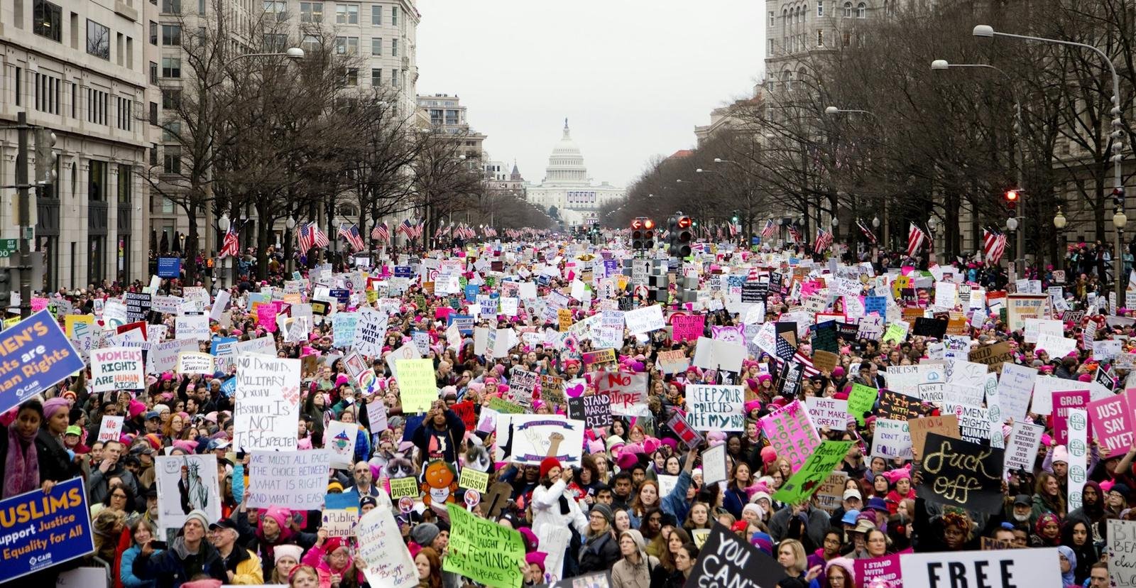 A very large march on a city avenue